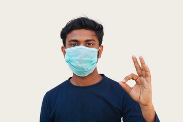 Young boy Wearing Protective Mask and Showing OK sign
