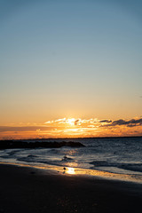 Sunrise over Atlantic Ocean with a red sky and red sunbeams and blue ocean water. 