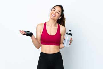 Sport woman over isolated white background with sports water bottle