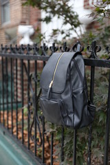 black backpack on a beautiful fence