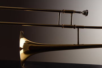 Backlit trombone with dark gradient background