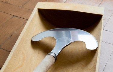 Obraz na płótnie Canvas manual metal hatchet chopper for vegetables and meat and a wooden Russian trough. for the manufacture of meat jellied meat and sauerkraut