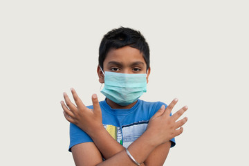 Boy wearing protective mask and show stop hands gesture for stop corona virus outbreak
