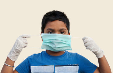 Boy wearing rubber glove using medical protective mask to health protection from Corona virus
