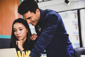 Happiness business young couple lover working at desk in the office.