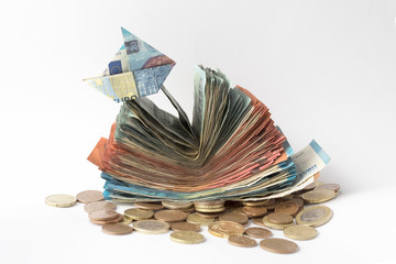 economy money europe and a little boat made with a euro bill on top