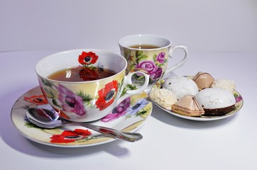 two mugs of fragrant tea and sweets