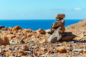 Fototapeta na wymiar cairn on a rock against the background of the sea