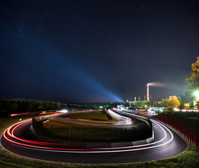 Night racing track with light trails on the racing circuit