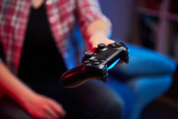 Gamer holding Gamepad, Controller or Videogame Joystick Console in hands. Close up, game concept