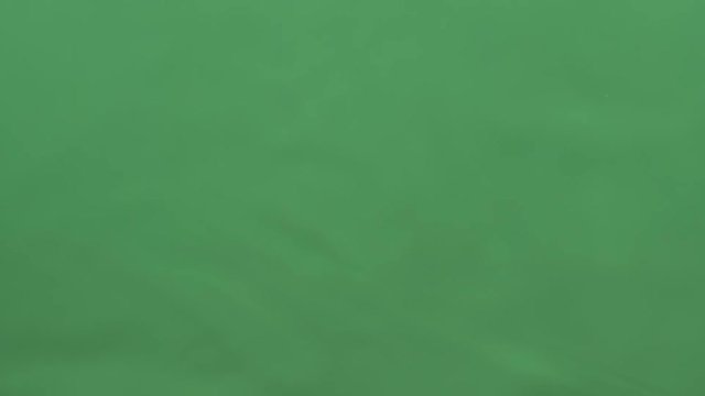 potato chips in free fall on a green background. Slow motion. Pringles
