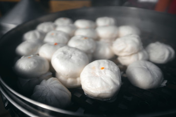 Street food of steaming  chinese local style pork bun.