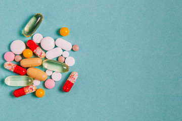 Antiviral pills, antibiotics, capsules, vitamins, healthy lifestyle concept, medical background with place for text top view