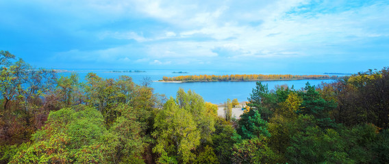 Panoramic view of the Dnieper River and bridge across it from the observation deck in the park of the Cherkasy city, Ukraine. Aerial view on the metal bridge over the Dnipro river in Cherkassy autumn.