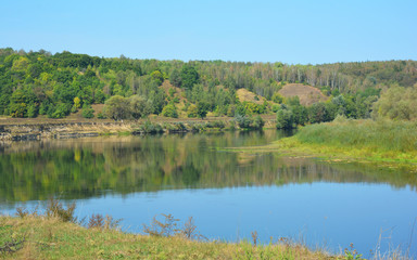 Picturesque landscape scenery of the Desna river with Mezyn National Nature Park in the background in summer.