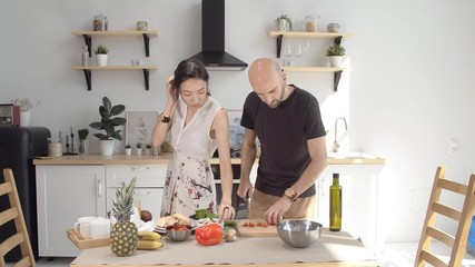 Happy family preparing breakfast together. Love, joy, smiles. Friendly family stayed at home in comfort and warmth. Stay home. Coronavirus or COVID-19. Girl smiles boyfriend in love.