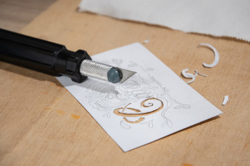 Paper stencil technique, cutting out illustration with the message Care with special knife