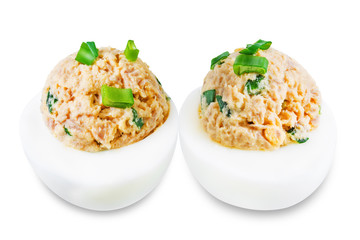 Canned Tuna deviled eggs with scallion on a white isolated background