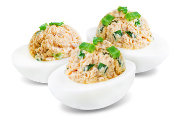 Canned Tuna deviled eggs with scallion on a white isolated background