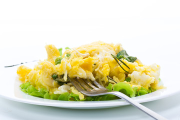 fried omelet with thin vermicelli with salad leaves in a plate
