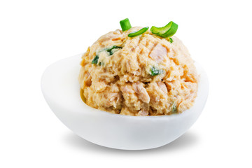 Canned Tuna deviled eggs with scallion on a white isolated background