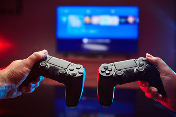 Gamer holding Gamepad, Controller or Videogame Joystick Console in hands. Close up, game concept - 336472036