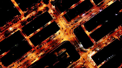 Aerial top down view on neighbourhood with geometric blocks and cars in between