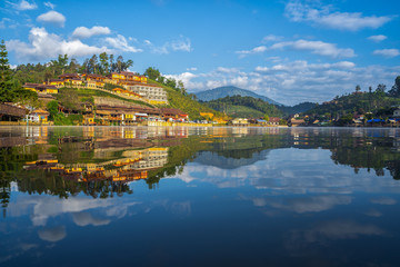 Obraz premium Mirror Lake of Ban Rak Thai, or Mae Aw, a Chinese Yunnan village on lakeside in Pai district, Mae Hong Son, Thailand