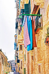 Old street with traditional houses and balconies Valletta