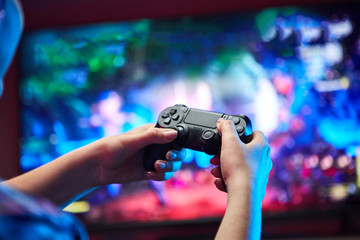 Gamer holding Gamepad, Controller or Videogame Joystick Console in hands. Close up, game concept