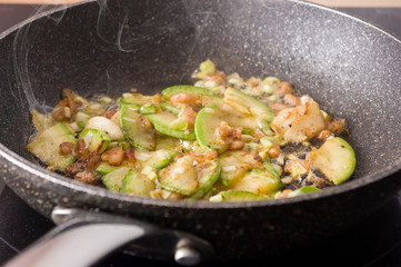 Scrambled eggs with garlic, zucchini, and shrimp. Cooking steps