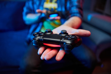 Gamer holding Gamepad, Controller or Videogame Joystick Console in hands. Close up, game concept