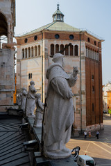 Cremona, Italy: View of the baptistery of the city and statue of a saint 