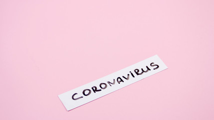 Fototapeta premium Nameplate coronavirus plate on a pink background