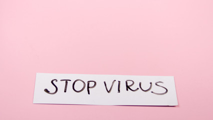 Nameplate stop virus plate on a pink background