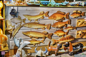 Wooden fish statues hanging at Riga Christmas market stand Latvia