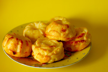Fresh muffins on exquisite traditional plate on yellow backround, beautiful breakfast, tea time