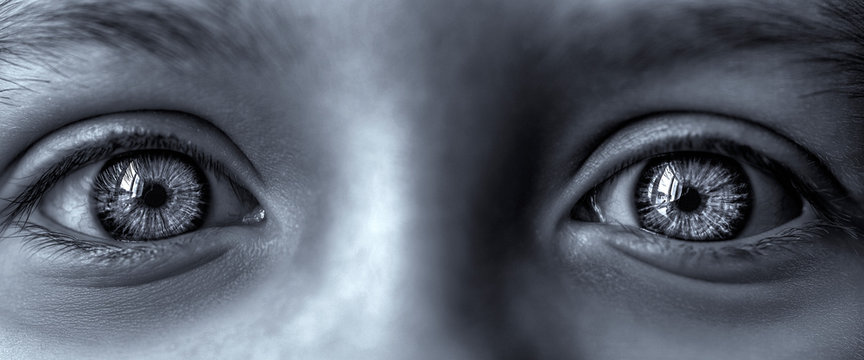 Big eyes of a child close-up. Black and white photo.