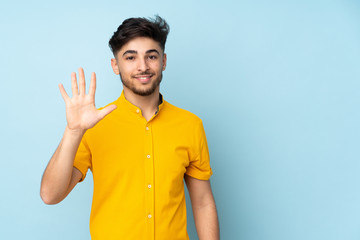 Arabian handsome man over isolated background counting five with fingers