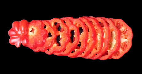 Sliced sweet pepper close-up on a black background, top view, flat lay, isolate, copy space.