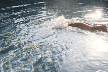 Person swimming in an outdoor pool
