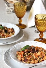 paella from orzo pasta with mussels, seashells and chicken. Seafood paella, traditional spanish dish. Paella on rustic black wooden table. Top view