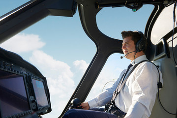 Male Pilot In Cockpit Of Helicopter During Flight © highwaystarz