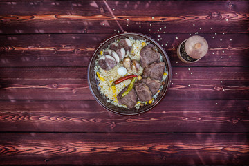 The concept of oriental cuisine. National Uzbek pilaf with meat. Top view, copy space.