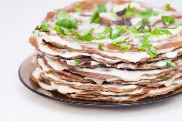 Liver cake closeup with mayonnaise on white background.