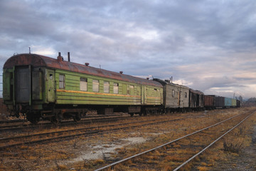 Fototapeta na wymiar Old cars on the abandoned station tracks in Russia