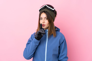 Young skier woman over isolated pink background doing silence gesture