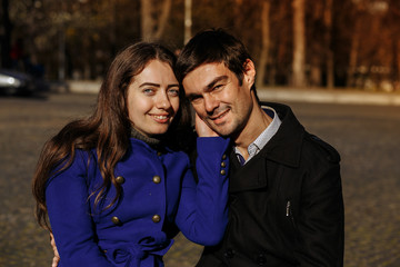 guy with a girl in the park on a sunny day. Autumn in the park. happy day