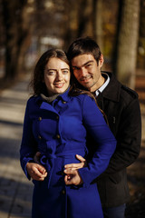 a guy with a girl walking in the park. Autumn in the park. sunny day