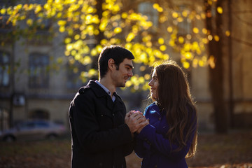 a guy with a girl walking in the park. Autumn in the park. sunny day